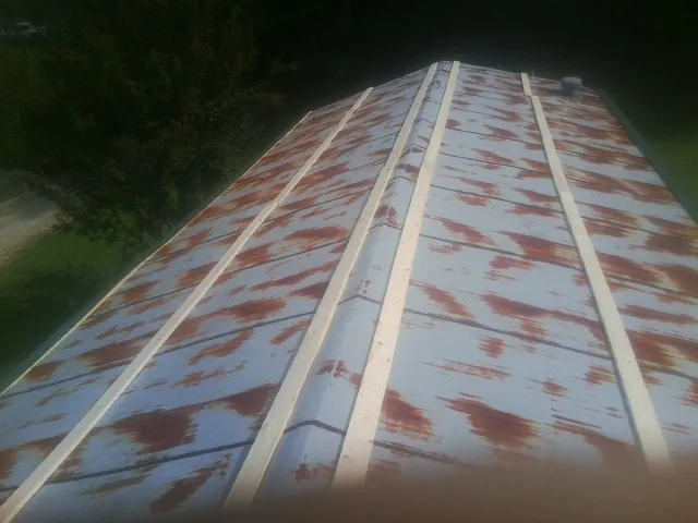Rusted metal roof panels with new wood purlins before replacement — Storm Damage Roof Repair in Boys Town by Roofing Brothers
